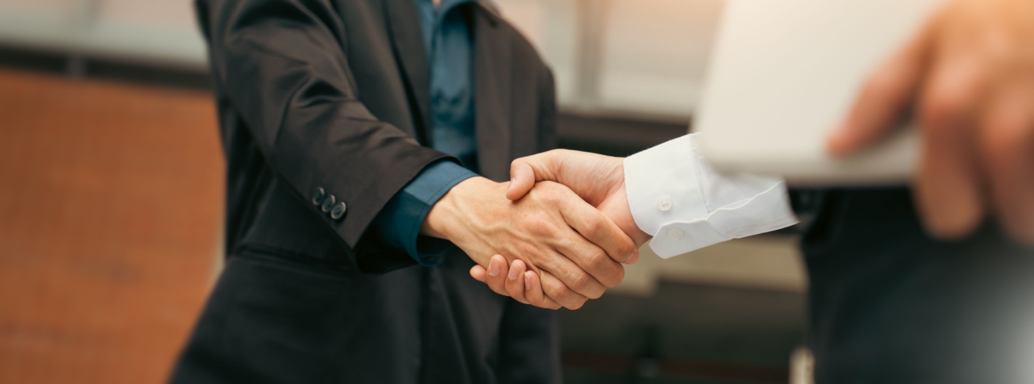 Two employees shaking hands