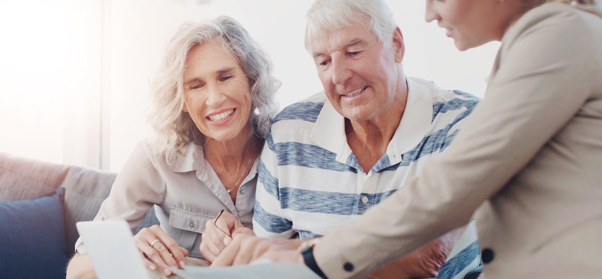 Paperwork, old couple and smile for retirement, laptop or financial advisor with senior people or planning. Happy, online and investment of fund, consulting or reading of payment in documents in home